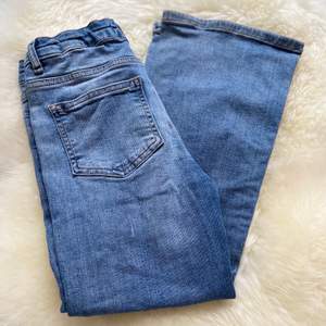 Ett par ljusblåa boot cut jeans och knappt använda 