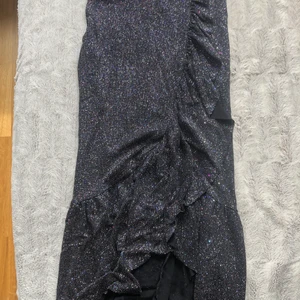 Glittrig tajt kjol storlek XS - Den är hyfsat lång och sitter tajt. Är i storlek XS. Den är inte använd alls många gånger kanske 3 gånger. Så den är i bra skick. Passar super bra till fester eller nyår. :)