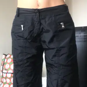 black pants with big pockets and strings at the end of the leg, mid waisted