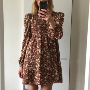Blommig klänning från asos - Brun klänning från asos, har sytt upp den så den skulle passa mig (är 164)