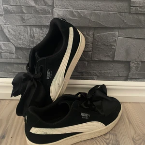Puma skor storlek 36 - Ett par puma skor med rosett knytning i storlek 36.🖤.    Väldigt få gånger använda, men har dessvärre två små märken från andra skor som stått emot dom.🖤 I priset ingår frakt. 