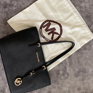 Michael Kors väska  - En nästan helt oanvänd väska från Micael Kors👜 Denna väskan är äkta och är köpt i New York på Sacks🌇 Nypris är 3 700kr. Den har en liten fraktpåse som följer med väskan (aldrig använd) Den kostar 1500 ink frakt, Pris kan diskuteras eller köp direkt för 1600 ink frakt♻️ ( Jet Set Medium Saffiano Leather Top-Zip Tote Bag) :) Om fler bilder önskas så är det bara att kontakta mig!