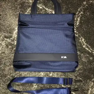 Waterproof navy tote from the brand Nava. Never worn, in perfect condition.