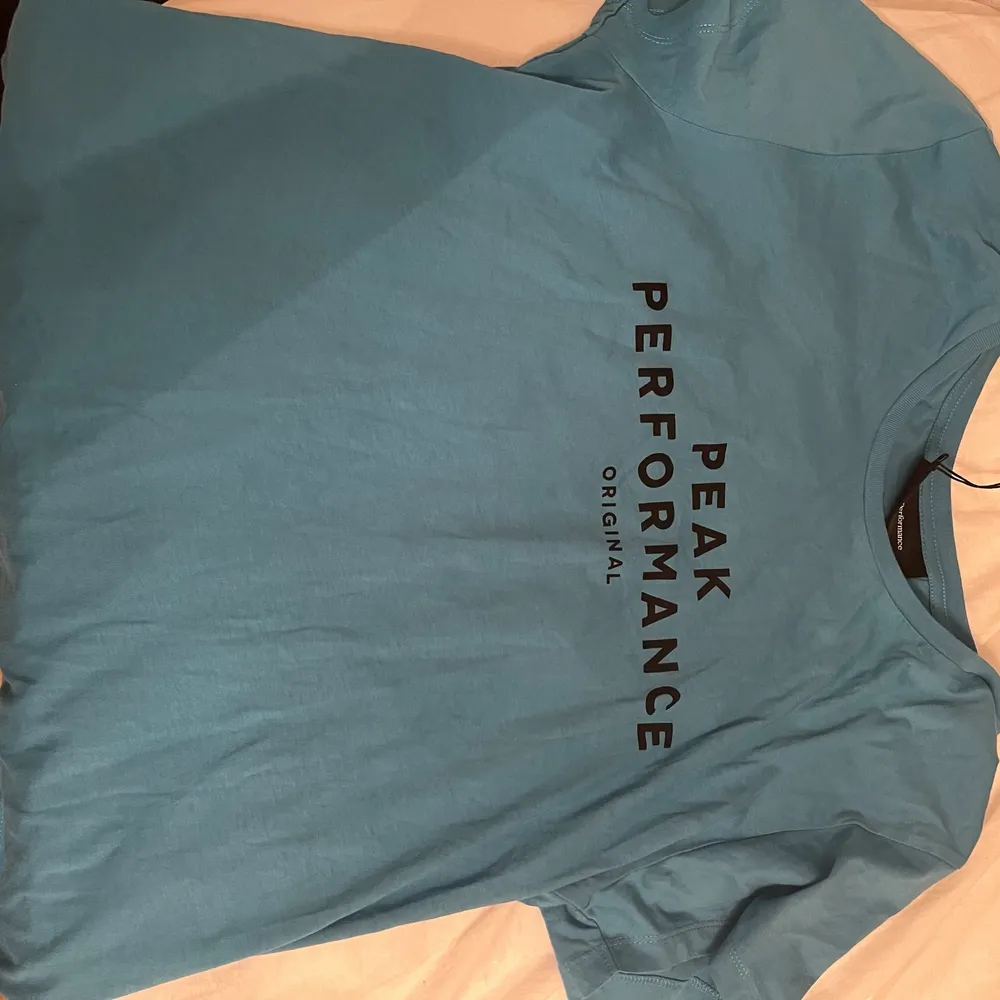 Blå T-Shirt från Peak Performance 💎 Endast provad pga inte min smak ☺️ Jättemjukt tyg, känns tightare än storlek L. M låter bättre! Frakt är på köparen! Nyskick 🥳. T-shirts.