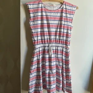 Randig klänning från Mango i storleken 152  - Plagget är använt max 4 gånger och är i ett väldigt bra skick. Plagget säljs för att det har blivit för litet. Klänningen är randig (blå och orange) Köpt för 299kr, och storlek 152 (11-12 år)