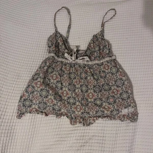 Odd Molly topp med rosett - Säljer en söt linne topp med ett detaljerat mönster i flera färger. Toppen har smala axelband och ett knytband framtill i siden. Toppen kommer från Odd Molly! Har tyvärr ingen bild på ☹️ Passar S och M skulle jag säga 💗