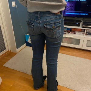 Low waist bootcut jeans från Levis - Säljer ett par snygga blå lågmidjade bootcut jeans från Levi's i modellen 'too superlow'. Midjemåttet är 37 och innerbenslängden är 80 (cm) ❤️ Jag kan sänka priset❤️❤️