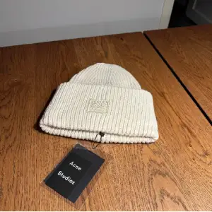 !!PRIS GÅR ATT DISKUTERA!! Säljer en superfin vit ribbad mössa från Acne Studios!❄️ Den är i nytt skick och perfekt för vintern. Mössan har en stilren design med en liten broderad detalj framtill. Passar perfekt för att hålla dig varm och snygg under kalla dagar!🩵