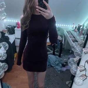 Mörk vinröd klänning från Gina Tricot - Snygg mörk vinröd klänning från Gina Tricot med en tight passform. Klänningen har långärmade och offshoulder-design som ger en trendig look. Perfekt för att sticka ut på festen!