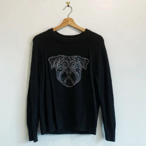 Svart tröja med pärlbroderad hund - Säljer en svart tröja med en unik pärlbroderad design av en hund på framsidan. Tröjan har långa ärmar och en rund halsringning. Perfekt för dig som vill ha något annorlunda i garderoben!