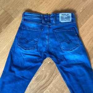 Replay blå jeans - Tja, säljer nu dessa riktigt snygga replay jeansen i storleken 31/30. Modellen är anbass och dom har en liten washed design i ljusblått. Anledningen till att jag säljer är att de har blivit lite för små. Inga synliga defekter och tveka inte att höra av dig med frågor!