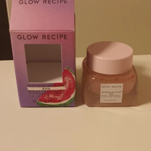 Glow Recipe Watermelon Glow AHA Night Treatment - Glow Recipe Watermelon Glow AHA Night Treatment är en nattbehandling med AHA-syra som ger huden lyster och återfuktning. Produkten kommer i en glasburk med rosa lock och förpackningen har en gradient i rosa och lila med en vattenmelonillustration. Produkten är helt ny. Nypris 250 kr