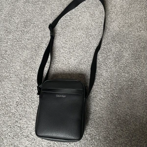 Svart axelväska från Calvin Klein - Säljer min Calvin Klein axelväska i läder med justerbar axelrem | Använd ett fåtal gånger | Skick 9,5/10 | Nypris: 900kr | Mitt pris: 399kr