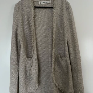 Cardigan, zara knit, M, guldfärgad - Guldmetallisk cardigan från ZARA knit i storlek M. I mycket fint skick. Material okänt då lappen är avklippt.   Mått:  Längd ca 60-80 cm (längre bak och kortare fram)  Ärmlängd mätt från axeln ca 65 cm