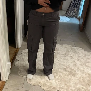 Grå cargobyxor från Ginatricot - Säljer ett par grå cargobyxor med flera praktiska fickor och en bekväm passform.