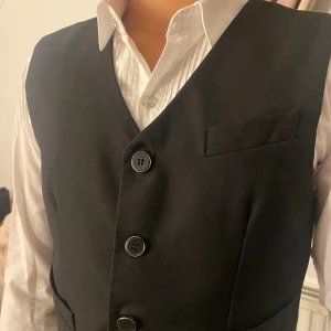 Väst  - En väst som passar perfekt över en skjorta som gör outfiten extra fin