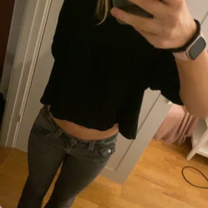 Svart croppad topp från Zara Trafaluc - Säljer en svart croppad topp från Zara Trafaluc. Toppen har en lös passform och är perfekt för en avslappnad stil. Den är tillverkad i ett mjukt material och har långa ärmar.