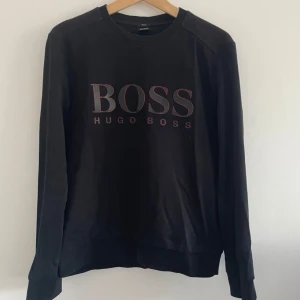 Hugo Boss Sweater - Hugo Boss Sweater - Svart  Storlek: M (Slim fit), sitter mer som en S då det är slim fit.  Är använd men i bra skick utan några märken osv!  Hör av dig vid funderingar!
