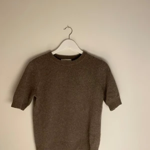 Beige kashmirtröja från Wakakuu Icons - Säljer en lyxig beige kashmirtröja från Wakakuu Icon. Tröjan är i jätte bra skicka och korta ärmar och en rund halsringning. Tillverkad i 100% kashmir och är väldigt mjuk. Passar utmärkt för både höst och vår. Säljer pga för liten storlek. Small.