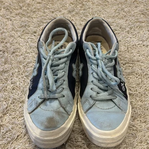 Golf le Fleur x Converse sneakers - Snygga Golf le Fleur x Converse sneakers i ljusblått och mörkblått. Skorna har en stjärndetalj på sidan och texten 'GOLF le FLEUR*'. De är utrustade med snörning och har en klassisk sneakerdesign. Bra skick men några saker som allt sys på bilderna 