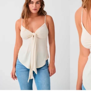 Beige linnetopp med knyt - Snygg beige linnetopp med smala axelband och knytning framtill. Perfekt för varma dagar och kan enkelt matchas med jeans eller kjol.