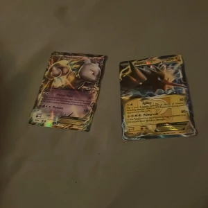 Pokémonkort Mewtwo och Zapdos - Två Pokémonkort till salu: Mewtwo och Zapdos. Mewtwo-kortet har en holografisk effekt med en kraftfull design, medan Zapdos-kortet visar den ikoniska fågeln med blixtar i bakgrunden. Perfekt för samlare eller Pokémon-fans!