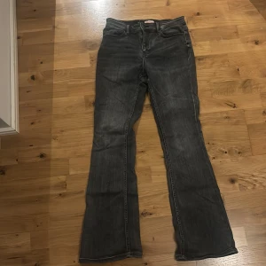 Grå bootcut jeans från Vero Moda - Snygga grå bootcut jeans från Vero Moda. De har en klassisk femficksdesign och är tillverkade i denim. Perfekta för en avslappnad stil med en touch av retro.