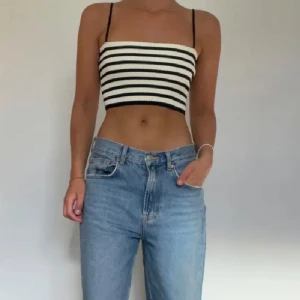 Randig ribbad tubtopp från Zara - Snygg randig tubtopp från Zara i svart och vit. Toppen är ribbad och croppad med smala axelband. 