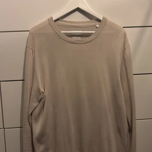 Beige tröja från These Glory Days - Säljer en stilren beige tröja från These Glory Days i bomull . Tröjan har långa ärmar och en klassisk rund halsringning. Perfekt för en avslappnad och bekväm stil. Och har ett riktigt bra pris med tanke på skicket storleken Xl men passar L hur bra som helst 