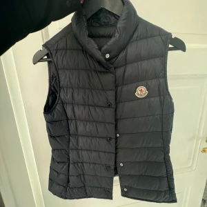 Moncler väst  - Så fin marinblå Moncler väst köpt på NK i Stockholm för runt 3400kr  Storlek 14y (164) motsvarar en xs/s skulle jag säga. Västen har fickor på sidorna. Jätte fint skick. (Skriv privat för fler bilder)😊