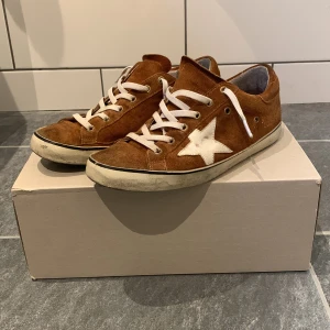 Golden Goose -  Tja! Säljer nu dessa stilrena och unika Golden Goose🍾. Skicket är hyfsat bra förutom sulan som håller på att lossna men går lätt att fixa. Storlek 41. Box ingår. Vid frågor är det bara att skriva🙌🏼