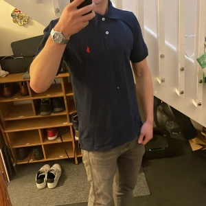 Marinblå Ralph Lauren piké - Säljer en mörkblå piké från Ralph Lauren i storlek S. Skulle säga att den här är något stor i storleken, men den har fortfarande fungerat bra för mig som har S i storlek. Använd endast ett fåtal gånger därav mycket bra skick.