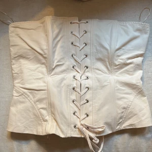 Ljusrosa korsett från Zara - Säljer en snygg ljusrosa korsett från Zara i storlek M. Den har en cool snörning framtill och dragkedja bak för enkel påklädning. Perfekt för en festlig kväll🎀