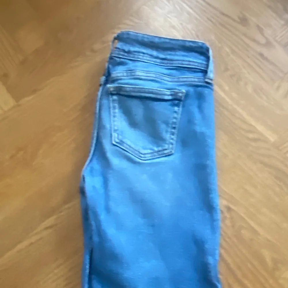 Super snygga low waist bootcut jeans med en fin detalj där nere och med två knappar❣️storleken står inte men skulle säga xxs-xs eller 152. Jeans & Byxor.