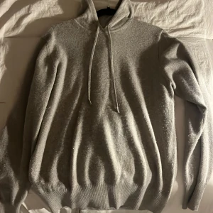 Brun hoodie från Soft goat - Säljer en mysig brun hoodie med dragsko i huvan. Tröjan har långa ärmar och ribbstickade muddar vid ärmslut och nederkant. Perfekt för kyliga dagar.