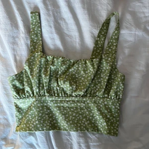 Grön blommig linnetopp - Söt grön linnetopp med vita blommor i bekvämt material! Mycket bra skick i uppskattad storlek S! PM för fler bilder💗