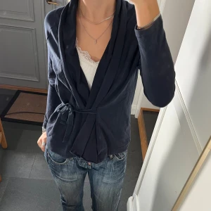 Blå knyttopp  - Mörkblå tröja med snörning från House of Lola i storlek M, passar även S. Fint skick. Använd gärna köp nu!