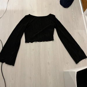 Svart ribbad topp - Säljer en svart lång ärmad topp. Passar både en xs och s. Bra skick.