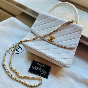 Authentic Chanel Timeless Classic  - Authentic Chanel Timeless Classic - a collector's item for Chanel lovers. Rare find in white and gold details.  It has a top handle and signature chain straps to wear as a shoulder bag or cross body.  The bag is never worn, in great vintage condition