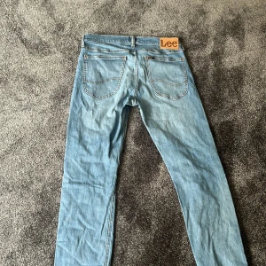 Lee jeans  - Säljer ett par ljusblå jeans från Lee, modell Luke. Jeansen har klassisk femficksdesign, raka ben och Lee-logga på bakfickan. Tillverkade i organisk bomull och passar perfekt till en avslappnad stil.