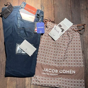 Mörkblå jeans från Jacob Cohën Limited Edition - Exklusiva mörkblå jeans från Jacob Cohën Limited Edition. Snygga detaljer och broderad text på insidan. Kommer med originalpåse och tillbehör.