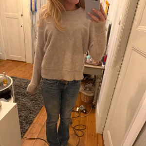 Beige stickad tröja - Mysig beige stickad tröja med rund halsringning och ribbade muddar vid ärmslut och nederkant. Tröjan är supersnygg med en massa detaljer!