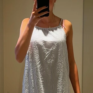 Randig blåvit sommarklänning H&M - Säljer en luftig och skön kortklänning från H&M i storlek 170. Klänningen är blåvit med smala vertikala ränder, har tunna axelband och är ärmlös. Tillverkad i 100% bomull, perfekt för varma dagar. Enkel och fräsch design som är lätt att matcha med sneakers eller sandaler.