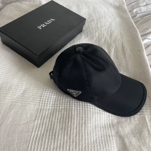 Prada keps  - Äkthetsbevis finns. Passar Onesize. Kommer med box. Skick 9/10🙂nypris 7000kr