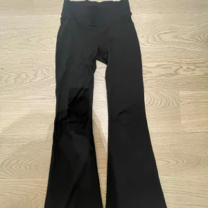 Svarta bootcut byxor från Gina Tricot - Svarta boutcut yougapants från Gina Tricot. stretchigt material och snygg passform med utsvängda ben som ger en trendig siluett. Jättefina topp skick men säljar pga att det blivit för små. Skriv gärna om fler bilder!🩷finns ej i butik längre(pris kan diskuteras)
