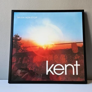 Kent - Albumaffisch, 31.5x31.5cm - Kent - Musik non stop albumaffisch, 31.5x31.5cm   Helt ny - Passar bra i IKEAs tavelram Lomviken!  Tryckt på glossy 240gr papper  Skickas i papprulle - Ramen ingår inte!