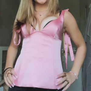 Rosa ZARA tröja - Supersnygg rosa korsett-topp i satin med breda axelband som knyts på axlarna från ZARA, har sytt axelbanden lite eftersom dom var för långa, skriv ifall ni vill ha mer bilder tex där jag sytt💓 