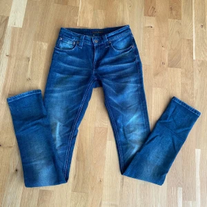 Mörkblå jeans från Nudie Jeans - Tja säljer dessa feta nudie jeans i storlek 26/34 passar som 26,27/32, modellen heter skinny lin och är som en skinny/ slim mer åt skinny hållet för det som söker den typ av passform. Skicket är 9/10 lite tecken på användning men inga fläckar eller liknande, för fler frågor kom privat👍👍
