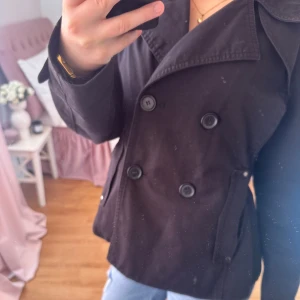 Svart kappa  - Snygg svart kappa med dubbelknäppning och klassisk krage. Från Kappahl i storlek xs, nypris runt 899kr.