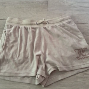 Juicy Couture shorts - Säljer ett par mjuka och sköna beige shorts från Juicy couture. JC-logga broderad framtill. Perfekta till sommaren.